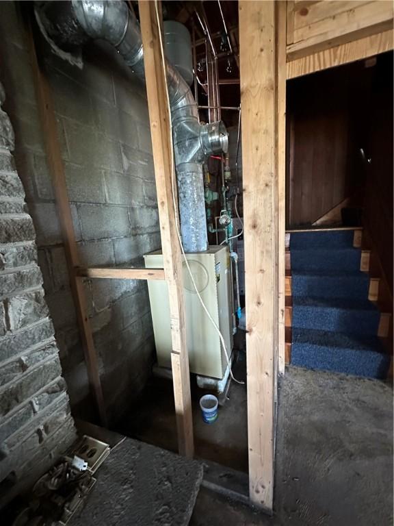 interior space with concrete block wall and stairs