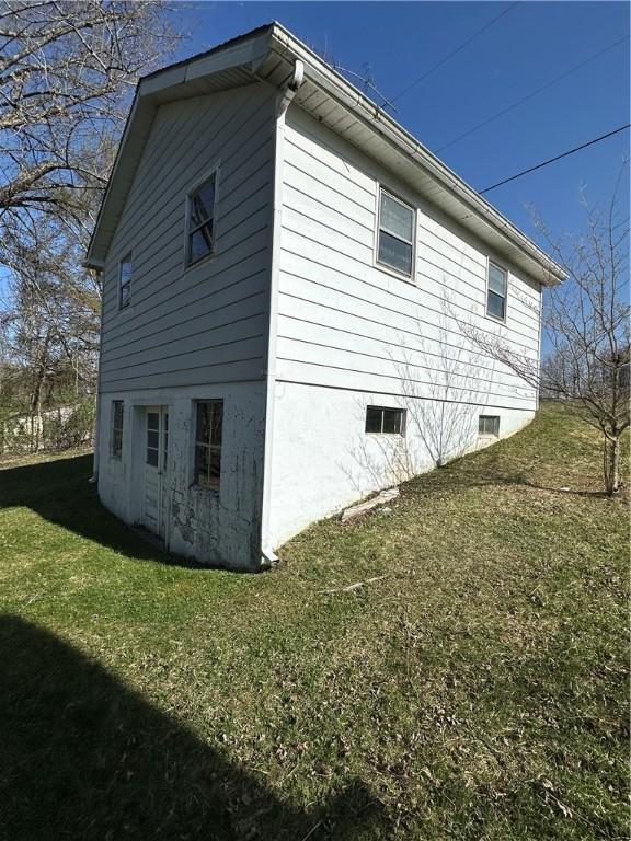 view of side of home featuring a lawn