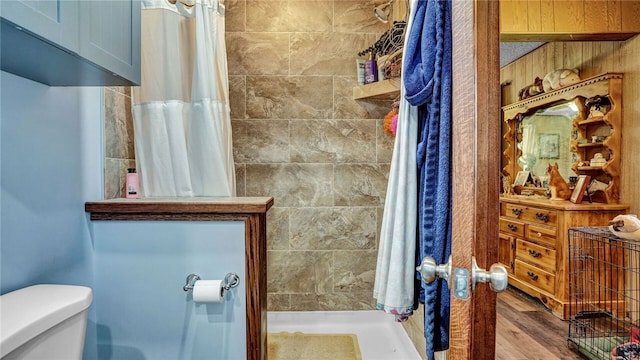 1029 Barden, Eldred, PA 16731 - bathroom with vanity, toilet, tiled shower, and wood finished floors
