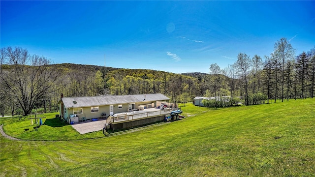 1029 Barden, Eldred, PA 16731 - back of house with a lawn, a deck, a wooded view, and a patio area