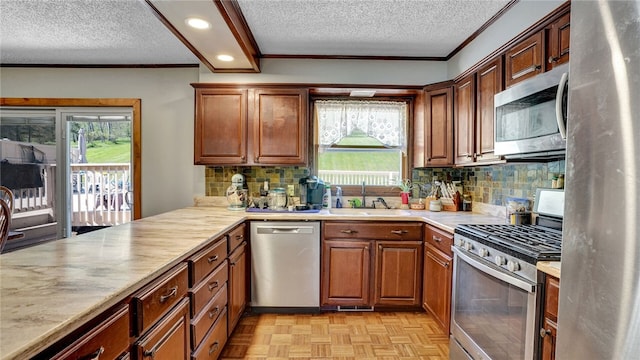 1029 Barden, Eldred, PA 16731 - kitchen featuring ornamental molding, light countertops, a textured ceiling, a sink, and stainless steel appliances