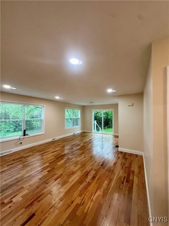 unfurnished room featuring recessed lighting, baseboards, visible vents, and wood finished floors