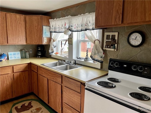 23183 Kitto Marina Dr, Brownville, NY 13634 - kitchen featuring decorative backsplash, electric range, brown cabinets, light countertops, and a sink