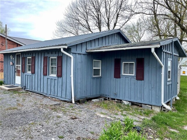 23183 Kitto Marina Dr, Brownville, NY 13634 - view of side of home featuring board and batten siding and metal roof