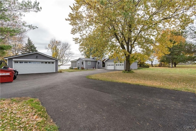 25524 County Route 57, Lyme, NY 13693 - view of front facade with a detached garage, an outdoor structure, and a front yard