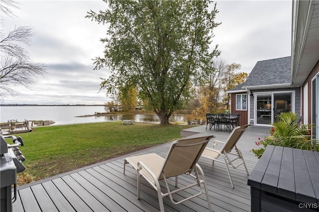 25524 County Route 57, Lyme, NY 13693 - wooden deck featuring outdoor dining area, a water view, and a yard