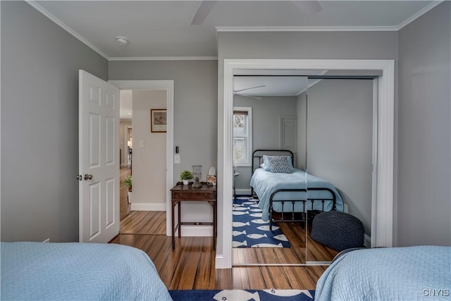 25524 County Route 57, Lyme, NY 13693 - bedroom featuring crown molding, a ceiling fan, a closet, and wood finished floors