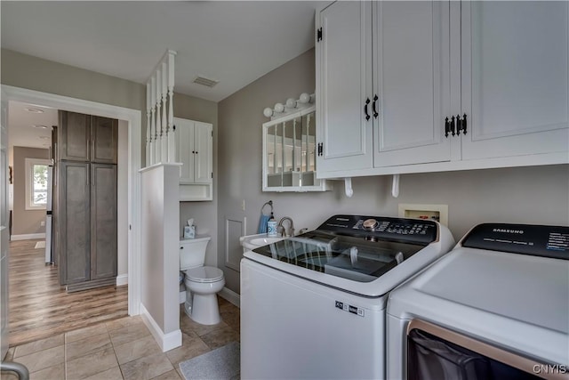 25524 County Route 57, Lyme, NY 13693 - clothes washing area featuring laundry area, a sink, baseboards, visible vents, and washing machine and dryer