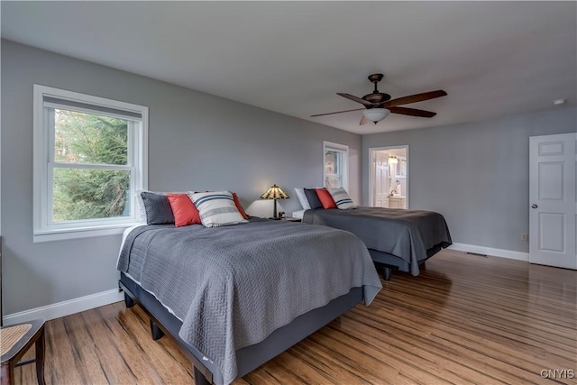 25524 County Route 57, Lyme, NY 13693 - bedroom featuring baseboards, a ceiling fan, connected bathroom, and wood finished floors