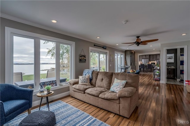 25524 County Route 57, Lyme, NY 13693 - living area with ornamental molding, wood finished floors, recessed lighting, a water view, and a ceiling fan