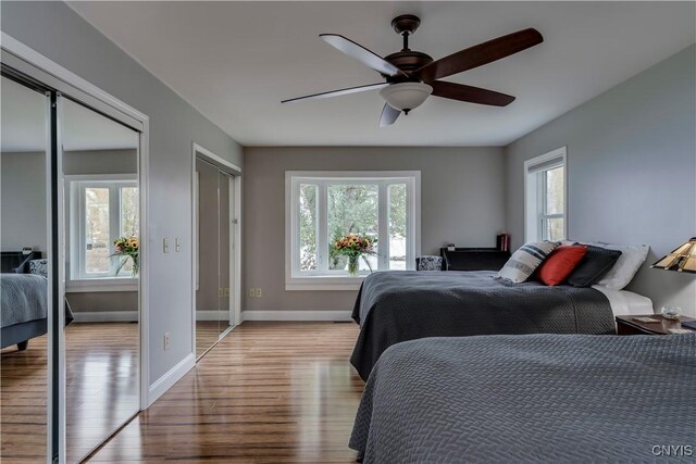 25524 County Route 57, Lyme, NY 13693 - bedroom featuring baseboards, multiple windows, two closets, and wood finished floors