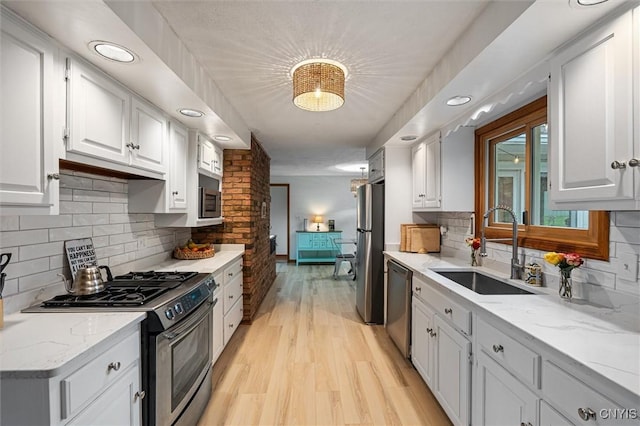 2380 E Lake Rd, Spafford, NY 13152 - kitchen featuring stainless steel appliances, a sink, white cabinetry, light wood-style flooring, and recessed lighting