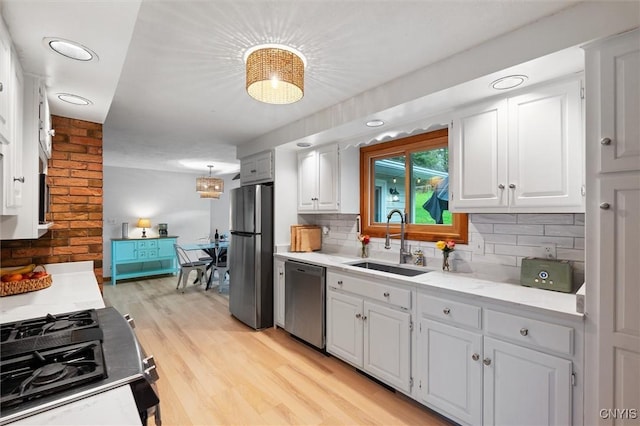 2380 E Lake Rd, Spafford, NY 13152 - kitchen featuring stainless steel appliances, a sink, decorative backsplash, and white cabinetry
