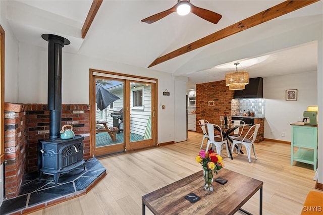 2380 E Lake Rd, Spafford, NY 13152 - living room with a wood stove, light wood finished floors, baseboards, and ceiling fan