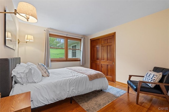 bedroom featuring wood finished floors and baseboards