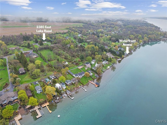 aerial overview of property's location with a large body of water and nearby suburban area