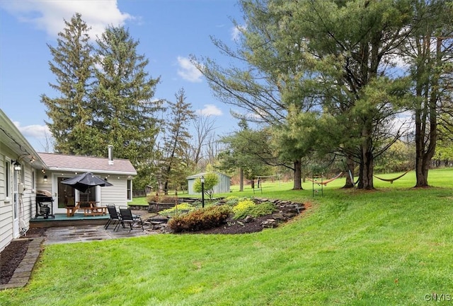 view of green lawn featuring a patio