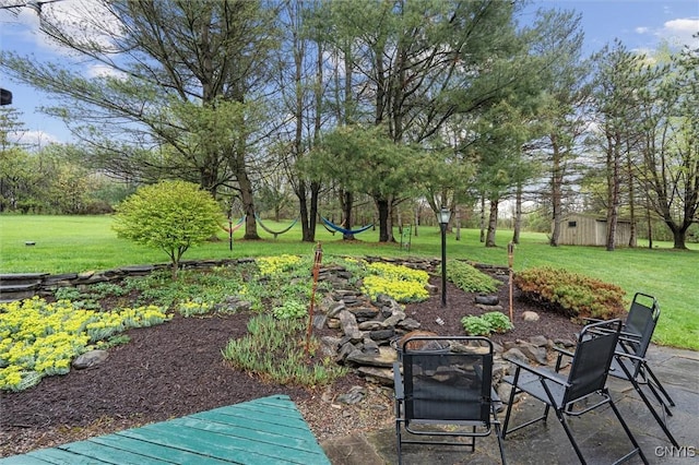 2380 E Lake Rd, Spafford, NY 13152 - view of green lawn with view of wooded area and a patio