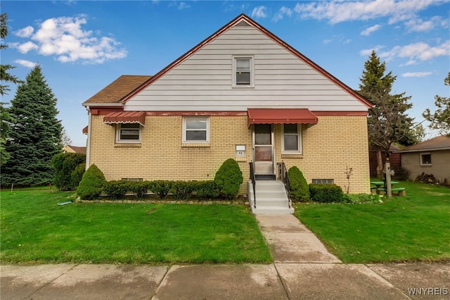 bungalow with brick siding, a front lawn, and crawl space