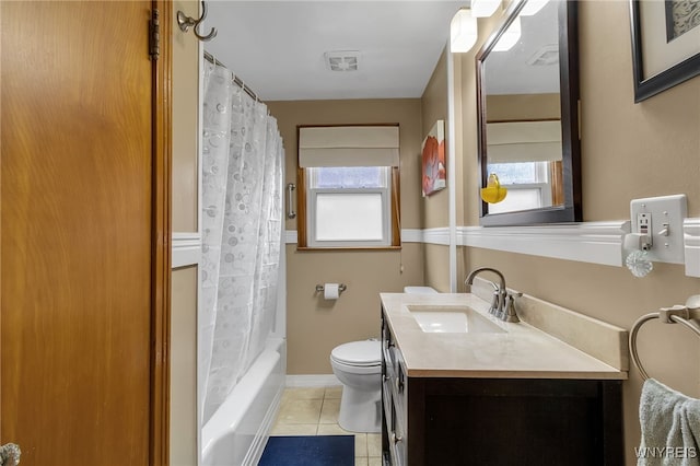 bathroom with toilet, tile patterned floors, plenty of natural light, and vanity