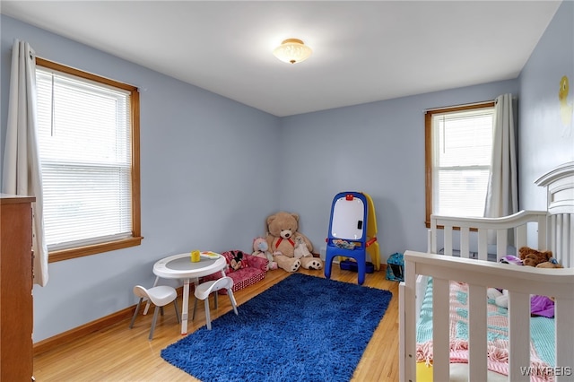 bedroom featuring baseboards and wood finished floors