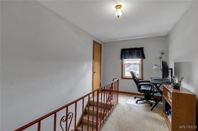 home office featuring baseboards and light colored carpet