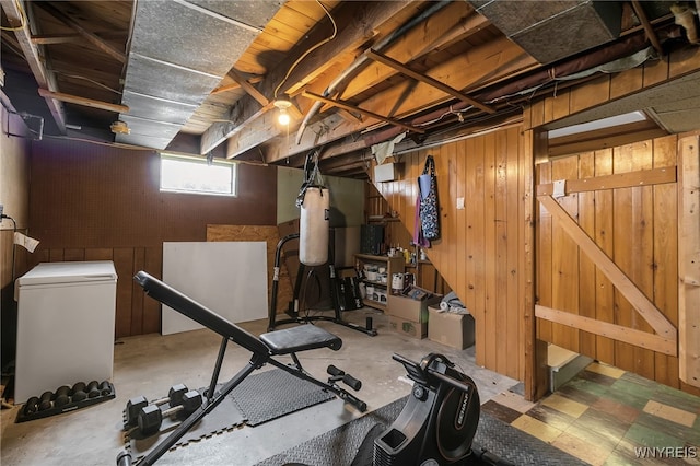 workout room featuring wood walls