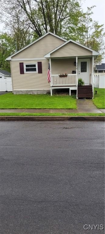 bungalow-style house featuring fence and a front yard