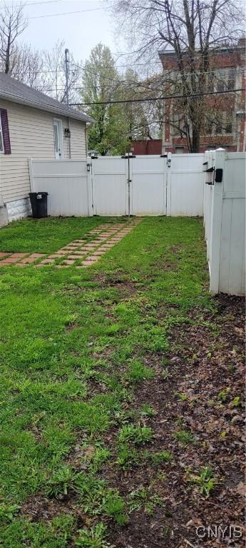 view of yard featuring a gate and fence