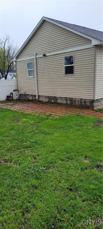 view of home's exterior with a yard and central air condition unit