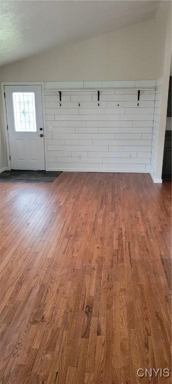 interior space featuring wood finished floors and lofted ceiling