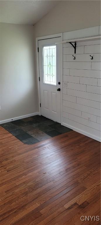 entrance foyer featuring baseboards, dark wood-style flooring, and lofted ceiling