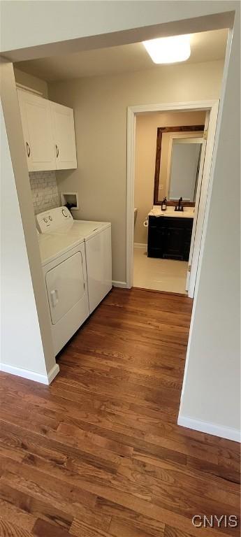 206 Oak St, Fulton, NY 13069 - laundry room featuring cabinet space, baseboards, and dark wood-style floors