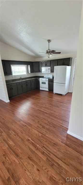 206 Oak St, Fulton, NY 13069 - kitchen with lofted ceiling, a ceiling fan, baseboards, white appliances, and dark wood finished floors