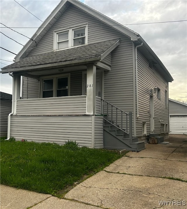 281 Roslyn Ave, Buffalo, NY 14215 - view of front of property with roof with shingles, covered porch, and a garage