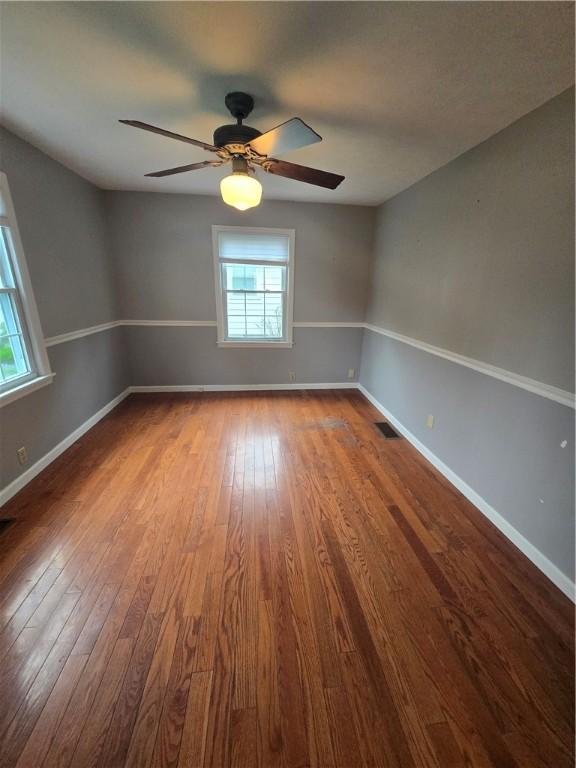 187 Cutler Ave, Corning-City, NY 14830 - unfurnished room with baseboards, visible vents, ceiling fan, and dark wood-type flooring