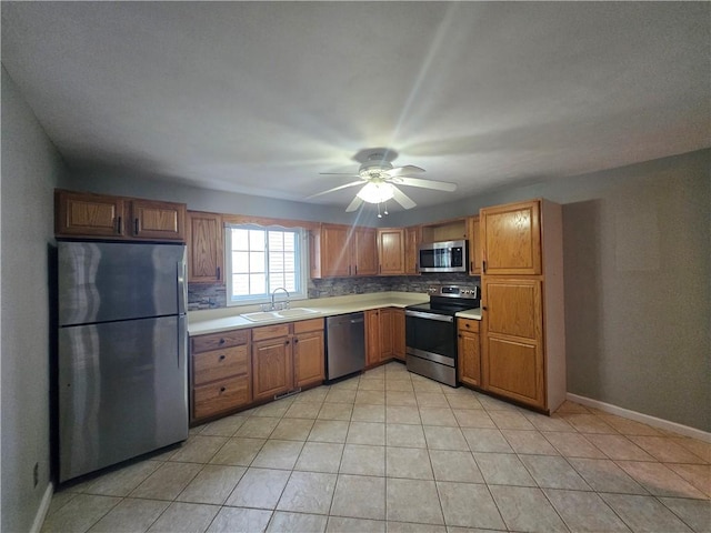 187 Cutler Ave, Corning-City, NY 14830 - kitchen with a ceiling fan, brown cabinets, a sink, light countertops, and stainless steel appliances