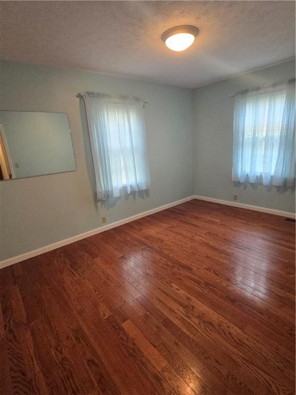 187 Cutler Ave, Corning-City, NY 14830 - unfurnished room featuring plenty of natural light, a textured ceiling, baseboards, and hardwood / wood-style floors