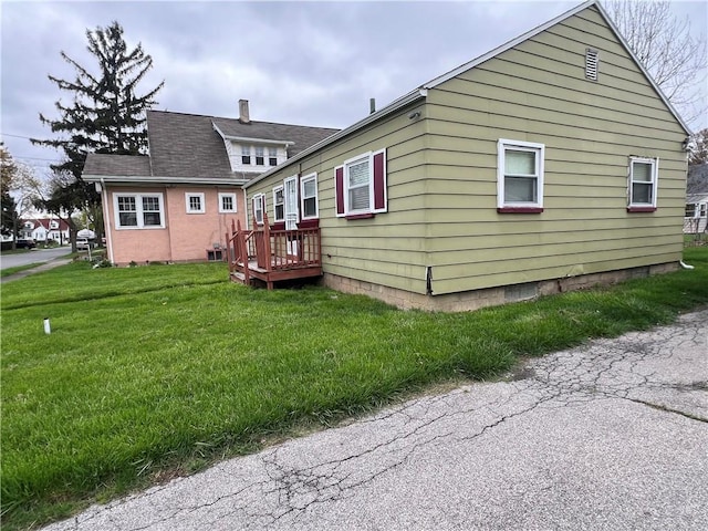 rear view of property with a lawn