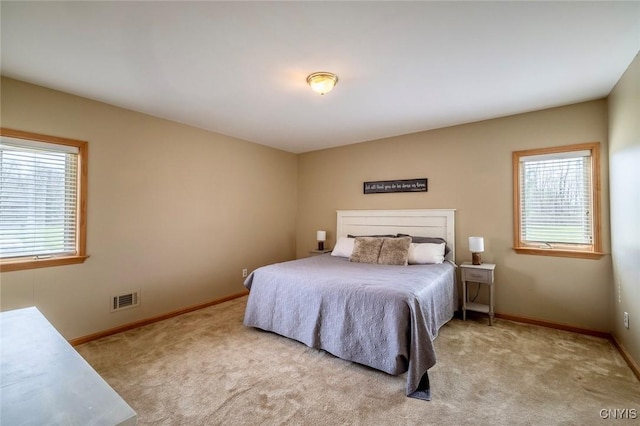 carpeted bedroom with baseboards and visible vents