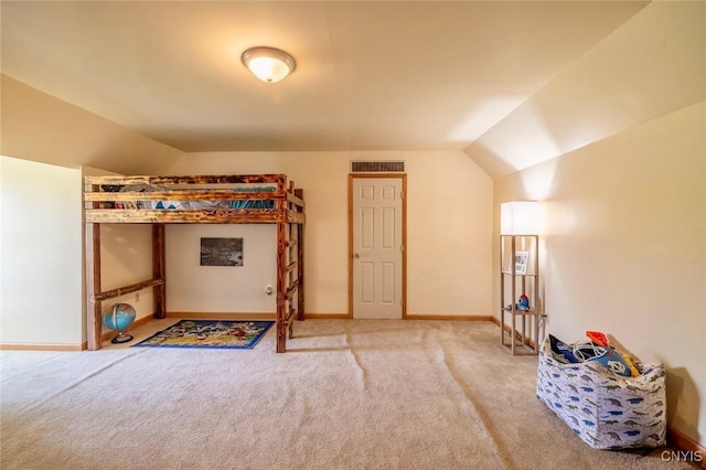 carpeted bedroom with baseboards, vaulted ceiling, and visible vents