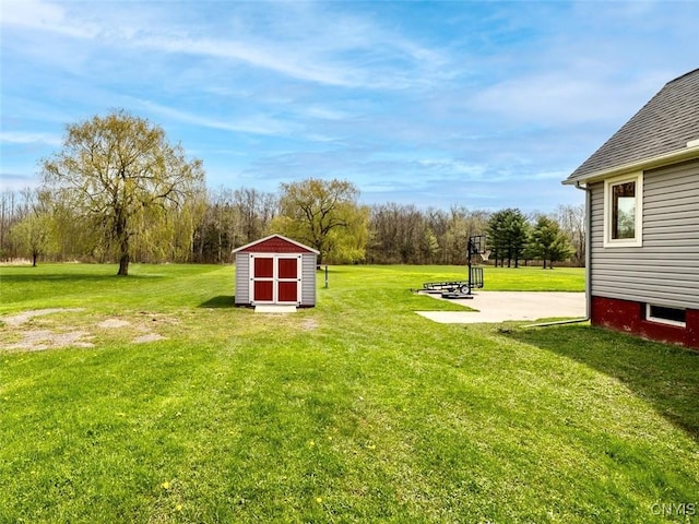 view of yard with a storage unit and an outbuilding