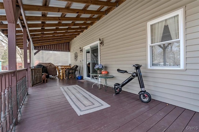 wooden terrace featuring outdoor dining area and area for grilling