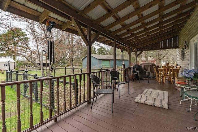 deck with a fenced backyard and a lawn
