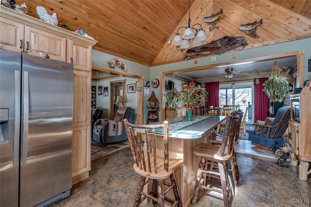 dining room with a ceiling fan, high vaulted ceiling, stone finish floor, and wooden ceiling