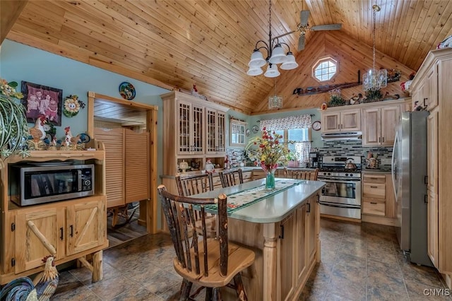 kitchen featuring appliances with stainless steel finishes, a center island, wooden ceiling, a notable chandelier, and under cabinet range hood