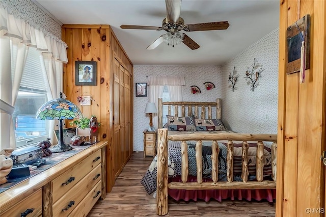 bedroom featuring wallpapered walls, ceiling fan, and light wood-style flooring
