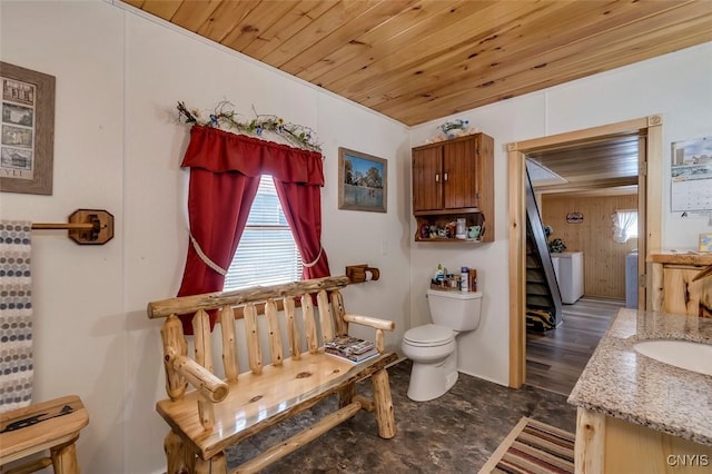 bathroom featuring toilet, wooden ceiling, and vanity