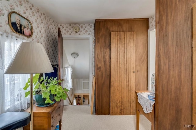 corridor featuring carpet flooring and wallpapered walls