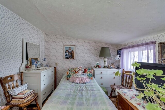 bedroom with wallpapered walls
